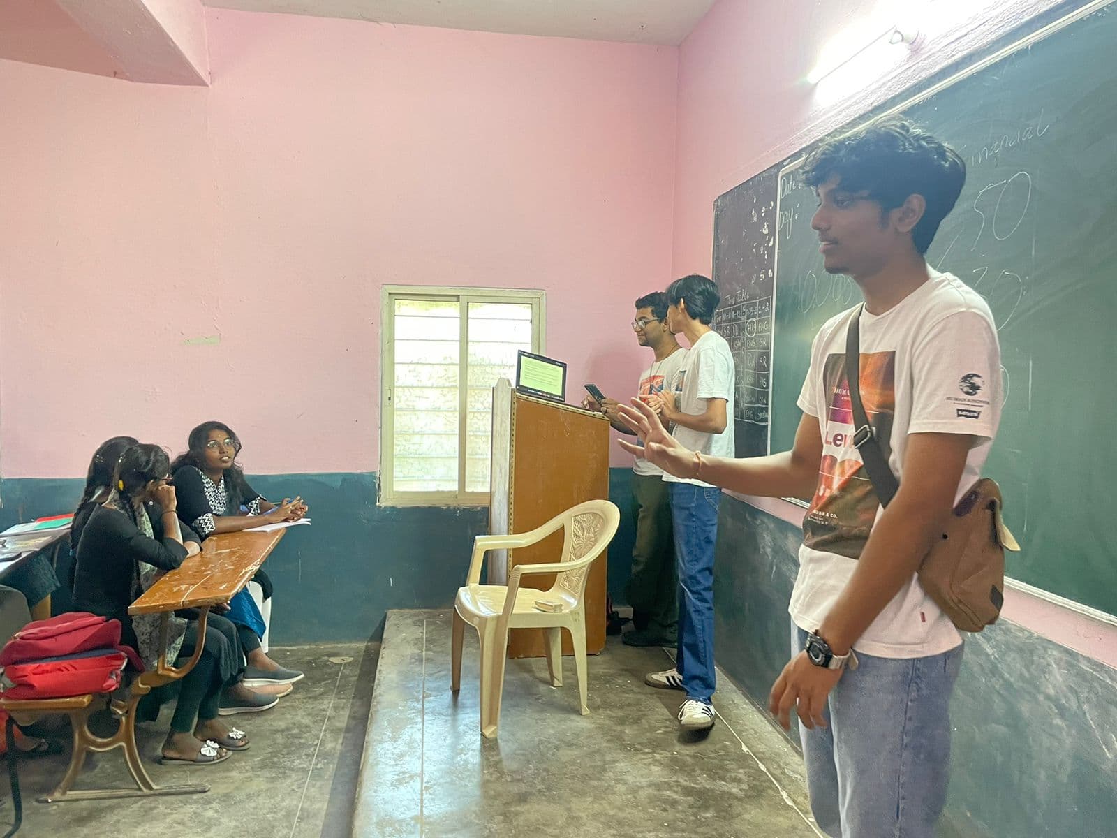 A Finance For All volunteer teaching at the front of a classroom