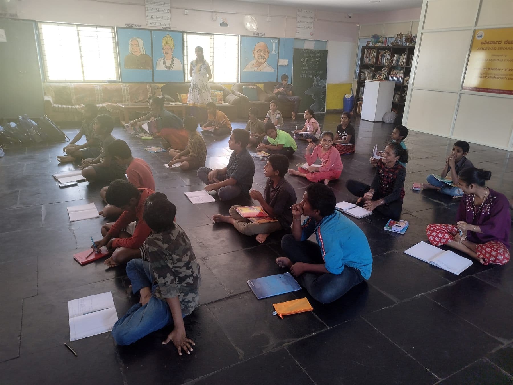 Students seated on the floor taking notes during a Finance For All workshop